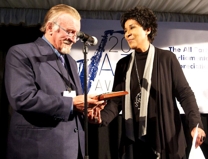 Acker receives his award from Moira Stewart