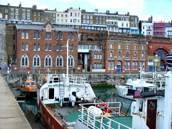 Military Road, Ramsgate Facing the Inner Harbour are the Seaman's Church and the Ramsgate Home for Smack Boys. Above, on the cliff, are the terraced buildings of Royal Parade.